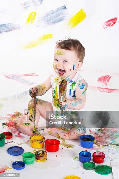 Young Child Covered In Colorful Paint And Making Mess Stock Photo - Download Image Now