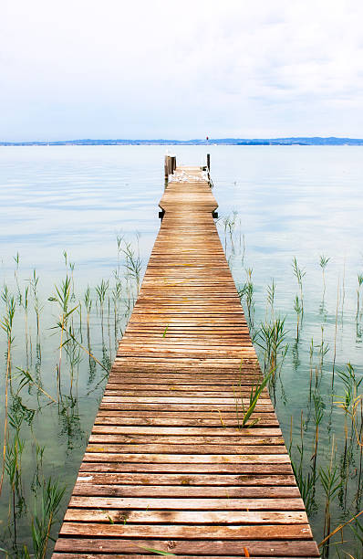 Old Pier on the Lake, Cloudy Sky stock photo