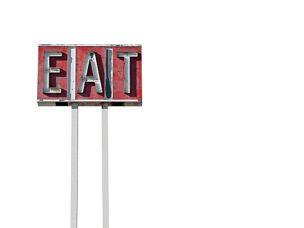 Tall eat sign ruin along a California desert highway.