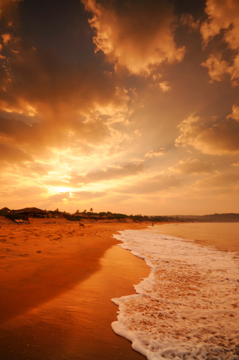 A view of a dramatic sunrise over Candolim Beach in Goa India. XL image size. 