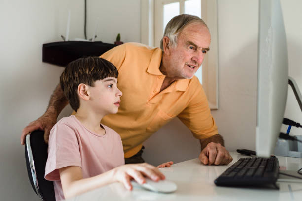 istock Homeschooling: boy studying at home with grandpa 1233859632