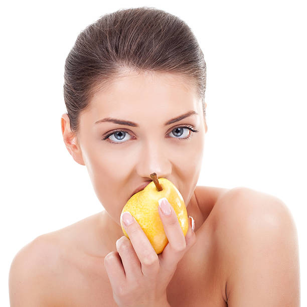 istock lovely woman eating pear 123390273