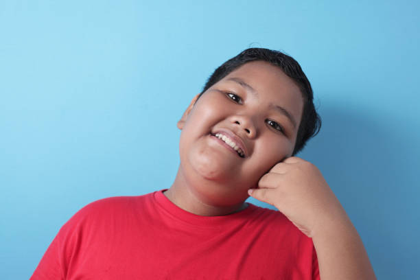 istock Cute Fat Asian Boy Looking at Camera and Smiling Happily 1234012606