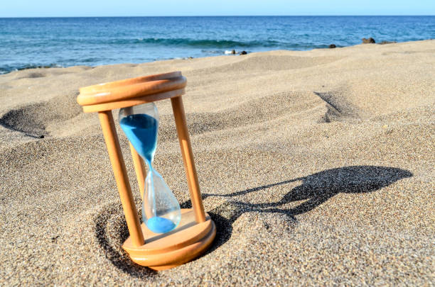 istock Hourglass Clock on the Sand Beach 1234055581