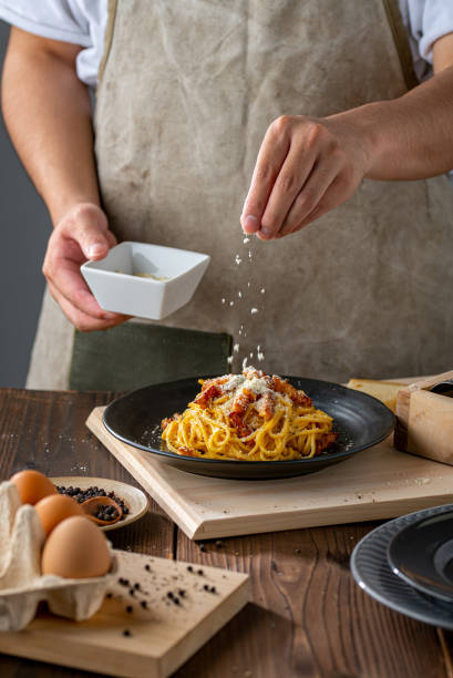 istock Delicious pasta carbonara on black plate. 1234074279