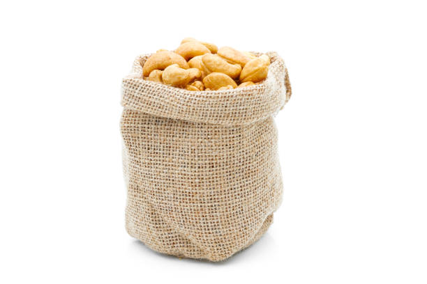 istock Cashews in a sack on a white background 1234154861