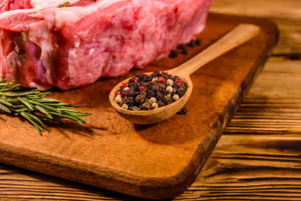 istock Raw pork ribs with spices and rosemary on a cutting board 1234196190