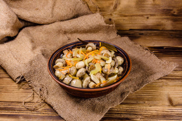 istock Canned mushrooms with carrot and onion in a ceramic bowl 1234196393