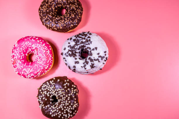 istock Fresh glazed donuts isolated on a pink background 1234196404