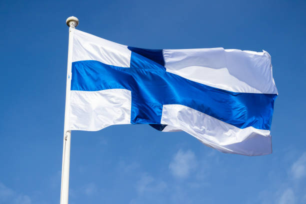 istock Finnish national flag on the wind against the blue sky 1234202117