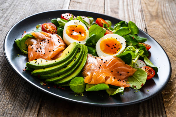 istock Smoked salmon with boiled eggs, avocado and vegetables on wooden table 1234298450