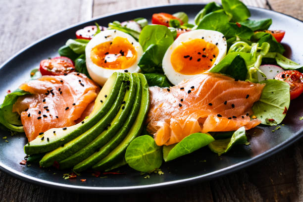 istock Smoked salmon with boiled eggs, avocado and vegetables on wooden table 1234298961