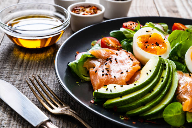 istock Smoked salmon with boiled eggs, avocado and vegetables on wooden table 1234299473