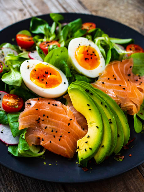 istock Smoked salmon with boiled eggs, avocado and vegetables on wooden table 1234300485