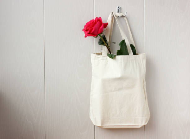 istock scarlet rose in a white cloth bag. 1234359528