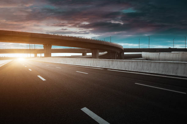 istock Dusk colored clouds in the background, highway overpass curved approach bridge 1234409231