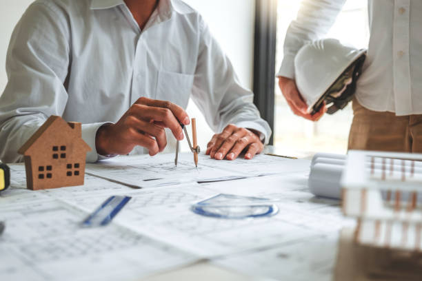 istock Team Engineer drawing graphic planning and meeting for architectural project on workplace 1234439190