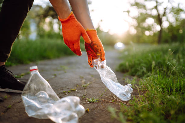 istock Men hand collects plastic trash for cleaning in the park. 1234451032