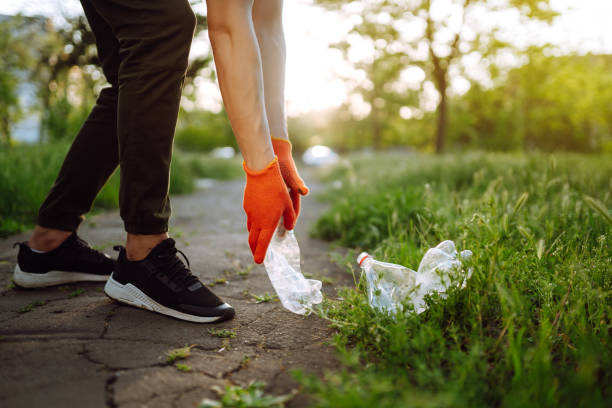istock Men hand collects plastic trash for cleaning in the park. 1234451623