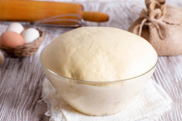 istock Yeast doughwith eggs on wooden table. Selective focus 1234458495