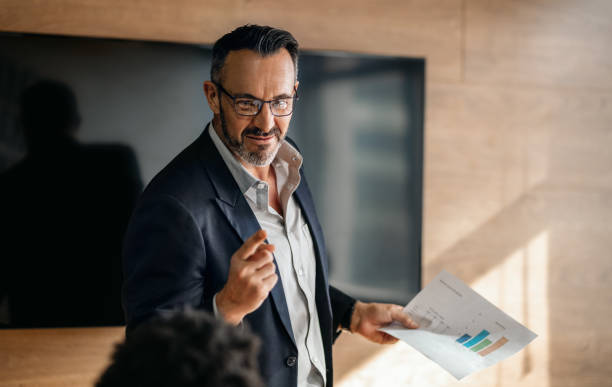 istock Manager discussing paperwork with staff during an office meeting 1234459375