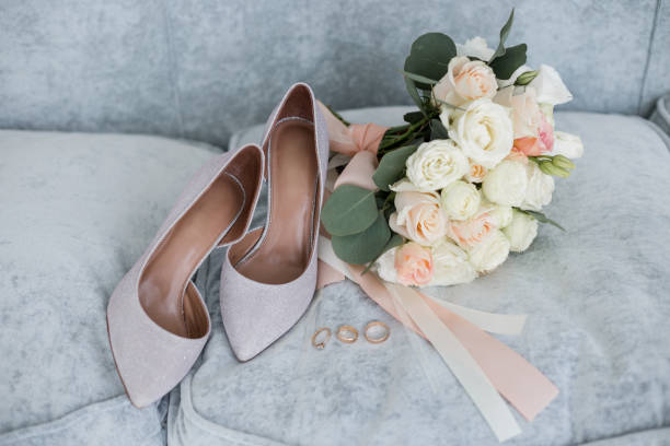 istock wedding gold rings with bride shoes and decor 1234471719