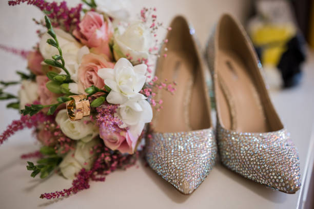 istock wedding gold rings with bride shoes and decor 1234486716