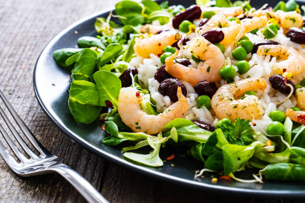 istock Prawns with vegetables on wooden table 1234490198