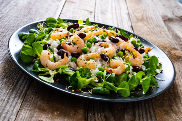 istock Prawns with vegetables on wooden table 1234491043