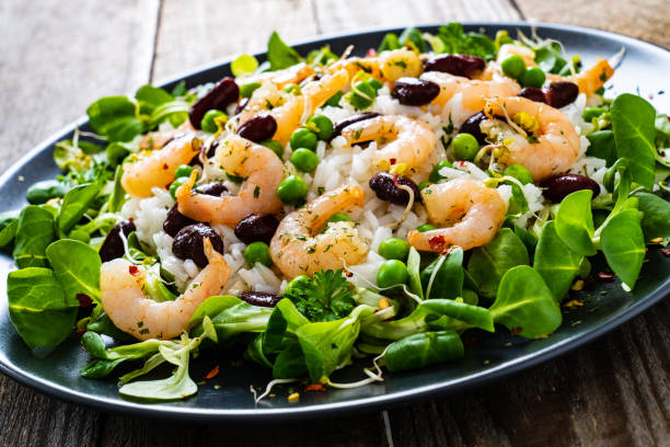 istock Prawns with vegetables on wooden table 1234491566