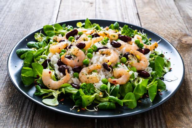 istock Prawns with vegetables on wooden table 1234492088
