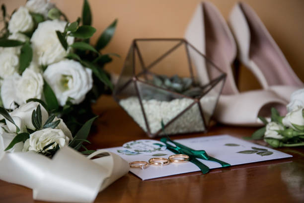 istock wedding gold rings with bride shoes and decor 1234497030