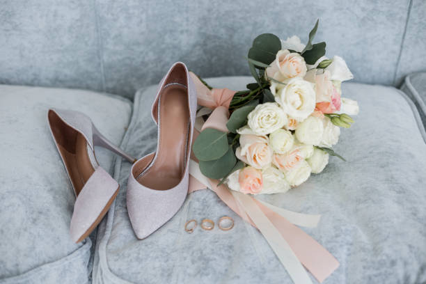 istock wedding gold rings with bride shoes and decor 1234507706