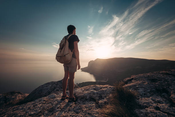 istock Man traveling with backpack hiking in mountains 1234508253