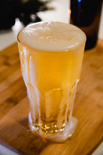 glass of beer on wood background