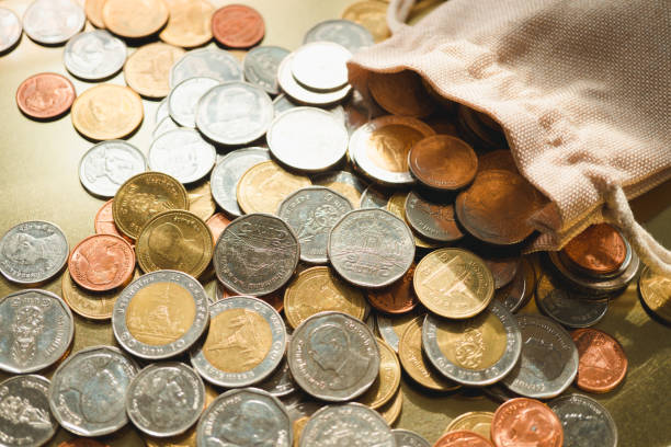 istock Closeup Thai baht coins release from cloth bag 1234539263