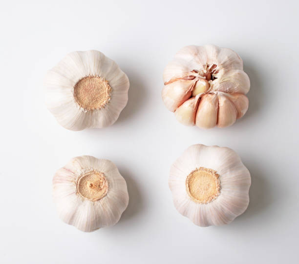 istock Modern layout of garlics with segments isolated on white background. 1234543485