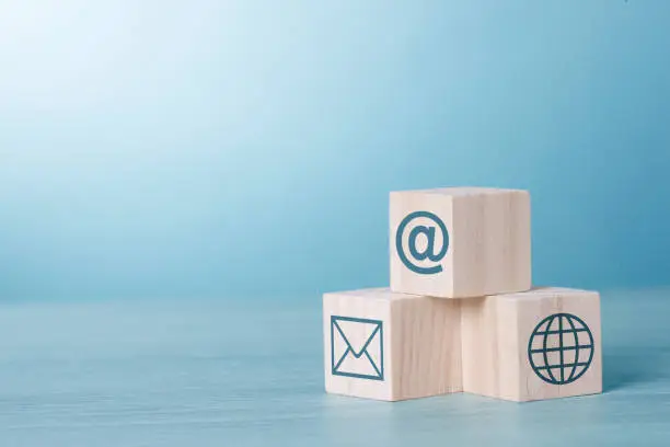 Wood Cubic on table Blue Tone Background with Email Network At sign icon : Social Network and www Internet Concept.