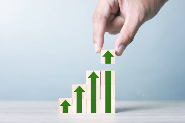 istock Wood block cubic stacking step up with Green Arrow Blue Tone. Business growth success process. 1234586461