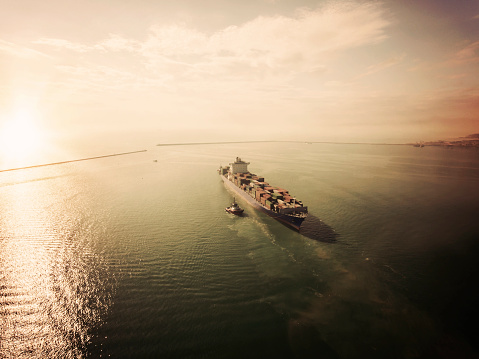 Retro style photo of container ship in export and import. International shipping cargo.
