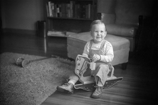 istock boy on rocking horse 1951, retro 123459428