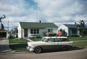 1956 Chevrolet parked in front of 50's home