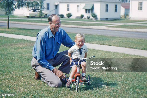 Grandfather Teaching Grandson To Ride Tricycle 1953 Retro Stock Photo - Download Image Now