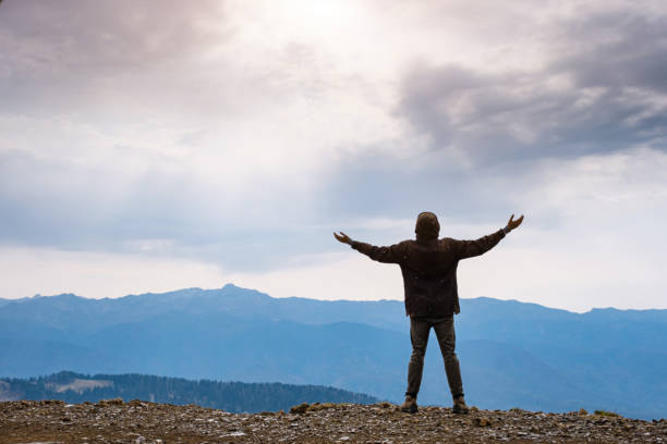 istock Landscape with silhouette of a standing happy man 1234602616