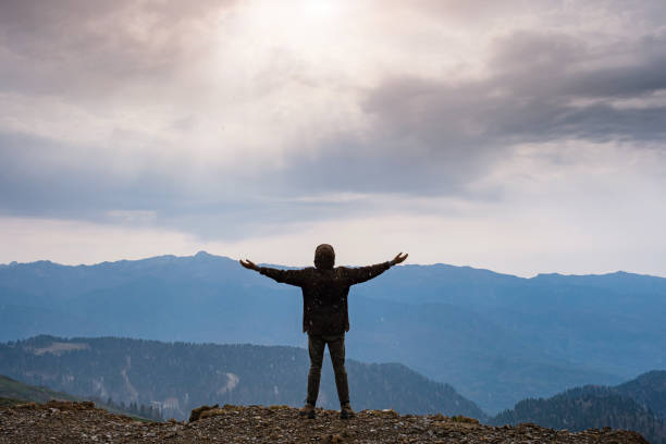 istock Landscape with silhouette of a standing happy man 1234602990