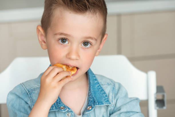 istock Cute little boy eats cookies. Homemade baked 1234607851
