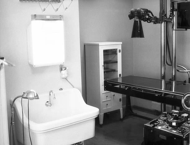 X-Ray machine 1959, retro X-Ray machine in veterinary hospital in 1959. Note photographic plates in cabinet. Same machine would have been used for human X-Rays. Kodak Plus X Pan scanned film with grain. 1950 1959 photos stock pictures, royalty-free photos & images