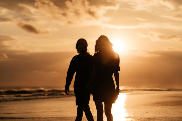 istock Attractive man and woman enjoying romantic evening on sunset 1234615676