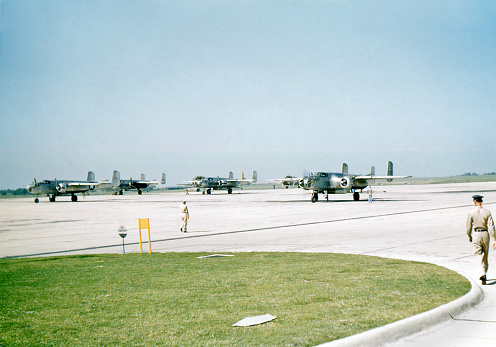 Flight line of B-25s at Randolph Field in 1949. San Antonio, Texas, USA. Scene would have been identical in WWII. Kodachrome scanned film with grain. Vignette in original film.