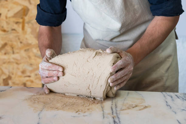 istock Potter sculpts from clay in a workshop of pots using ancient 1234617304